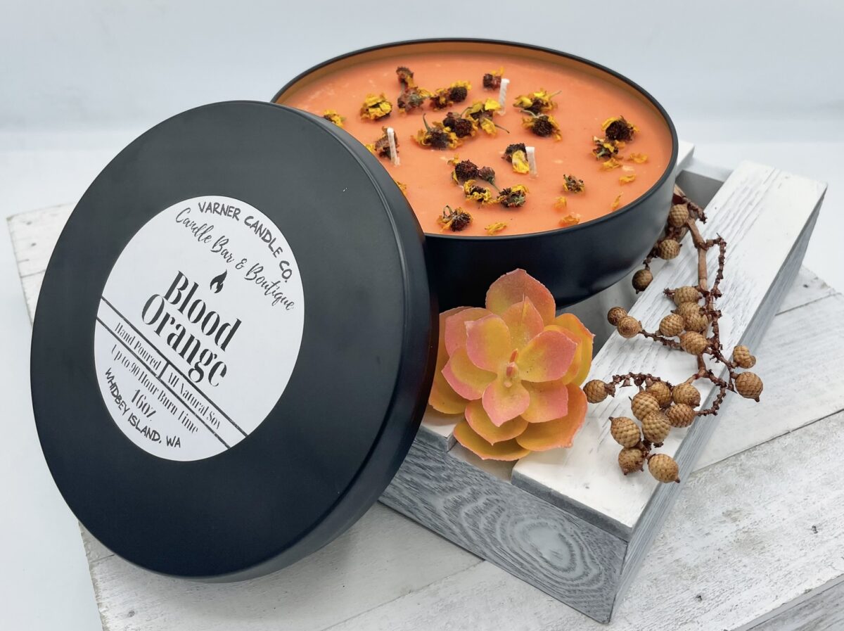 Blood Orange scented, orange wax in 16oz black tin container, topped with dried flowers