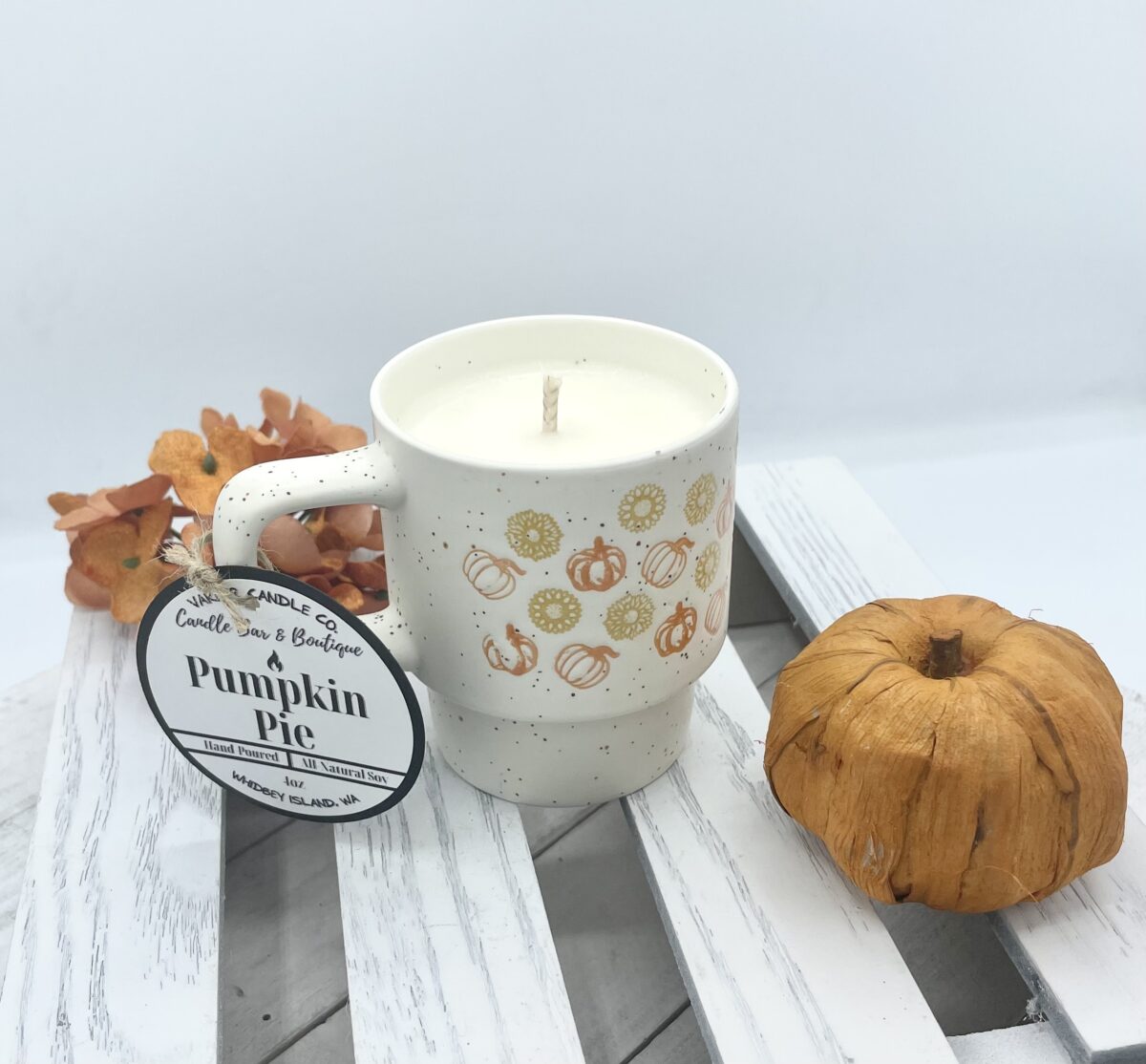 Scented soy candle in pumpkin pie, in a ceramic mug with cotton wick.